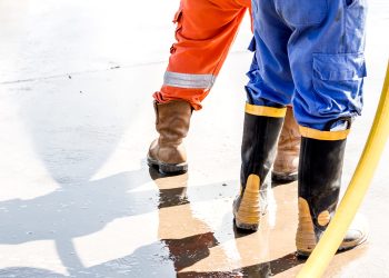 close up safety boos.Worker use boot for safety cleaning by water